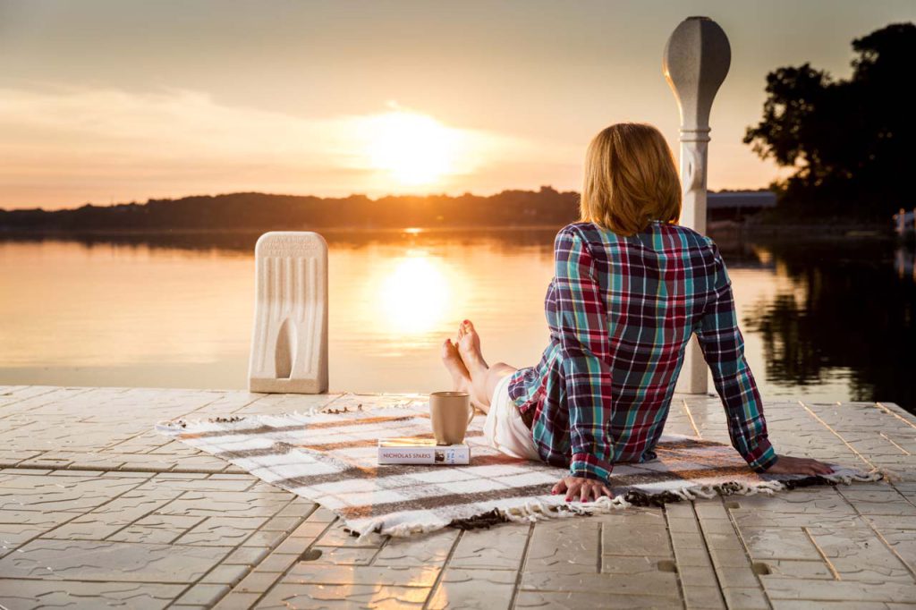 woman at the dock at sunrise